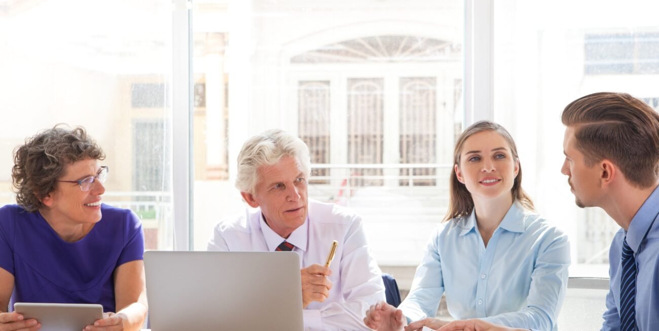 Group of four people discussing business issues