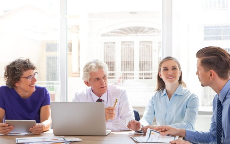 Group of four people discussing business issues