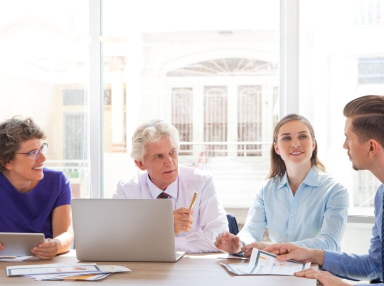 Group of four people discussing business issues